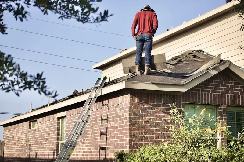 Professional roofer working on a residential roof in California Gardens